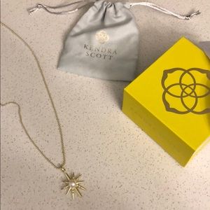 Gold Kendra Scott necklace.